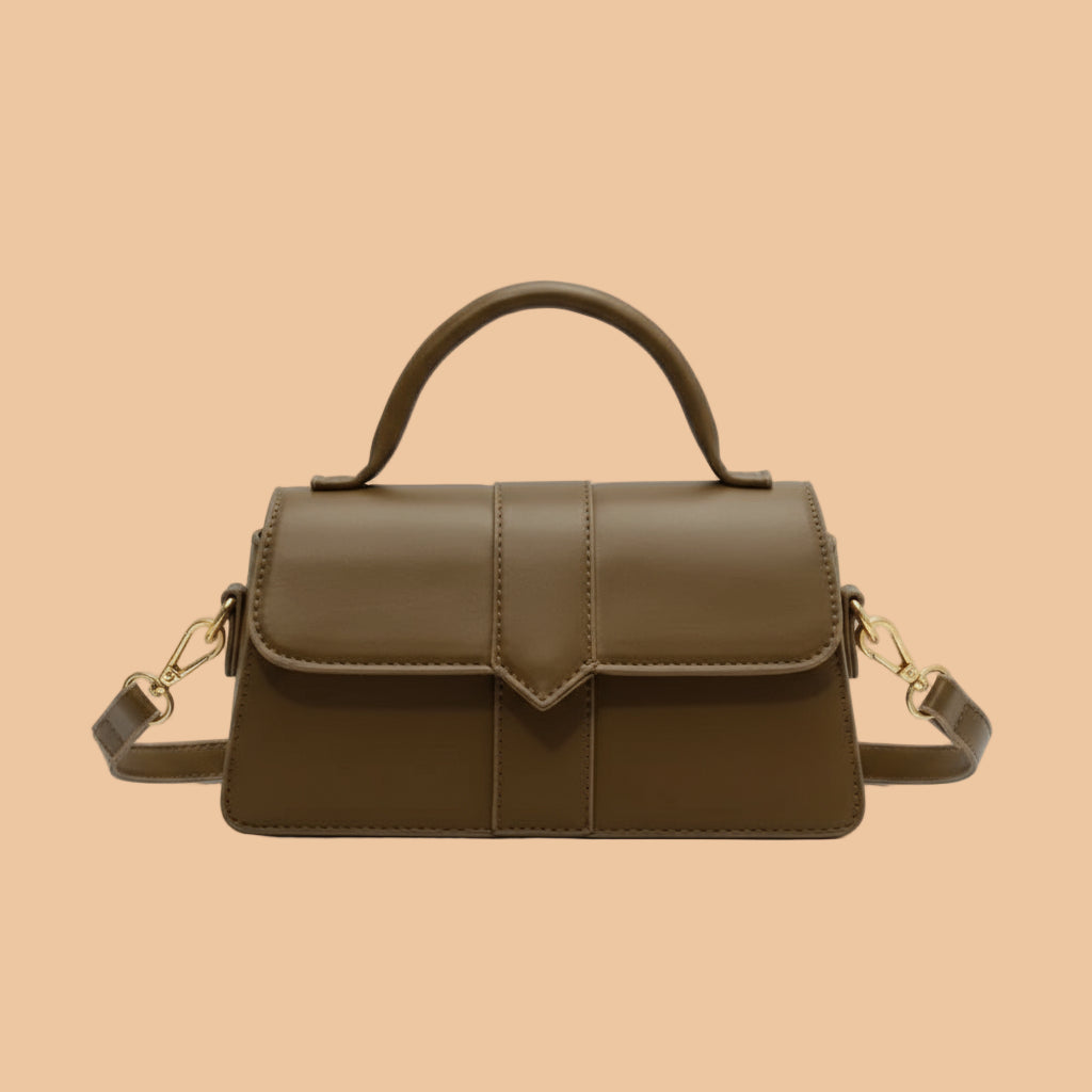 Brown handbag with gold accents on a white background